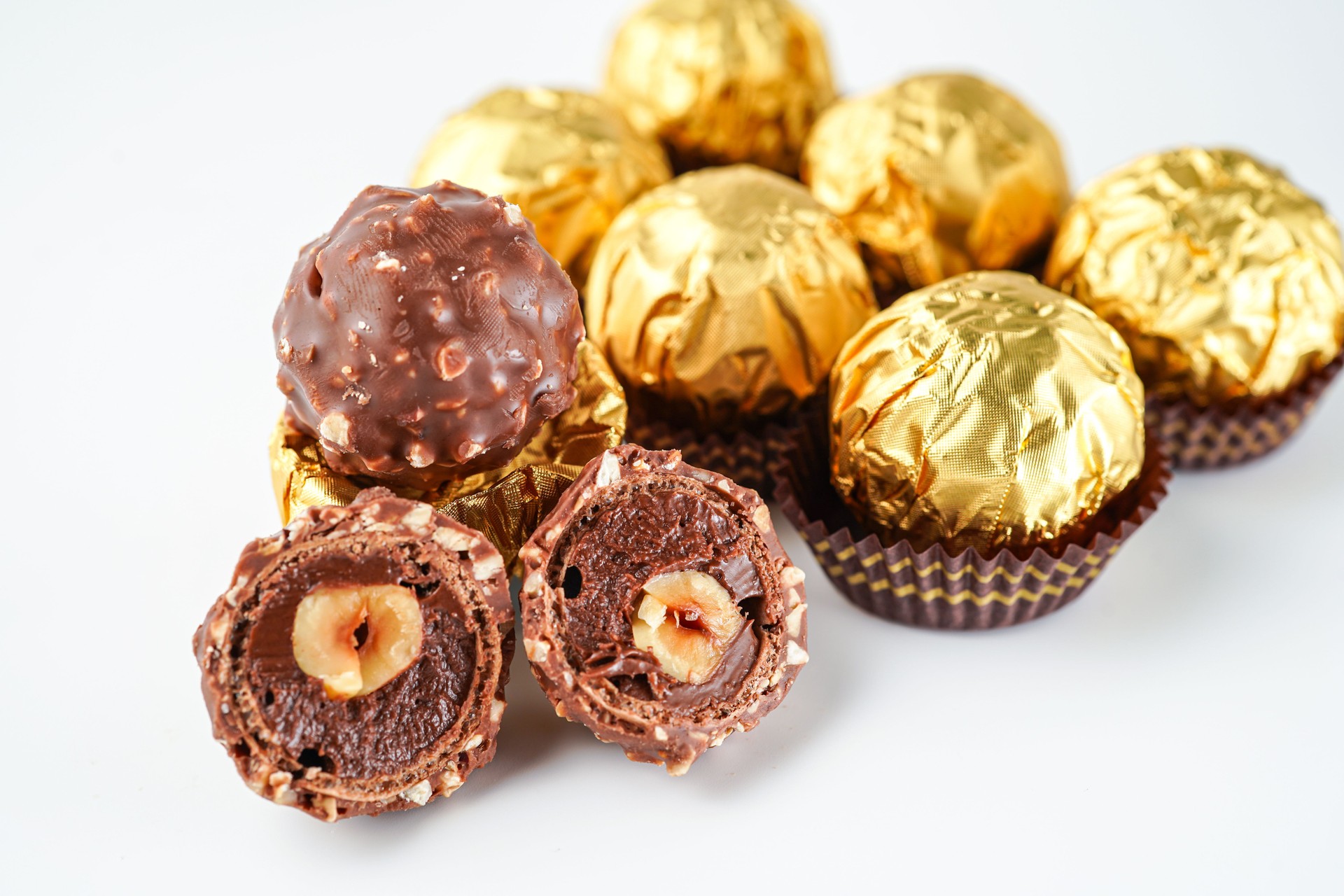 chocolate and hazelnut confectionery balls. chocolate sweet made. Chocolate candies in a gold wrapper